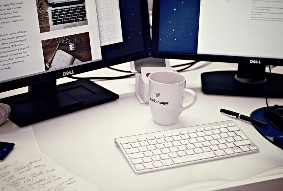 Un elegante escritorio de oficina con dispositivos Apple: iMac, MacBook e iPad.